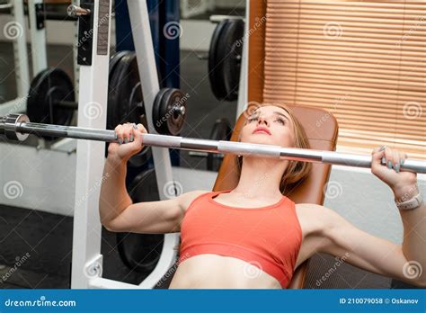 Young Woman Does Bench Press Workout in Modern Gym Stock Photo - Image of masculine, girl: 210079058