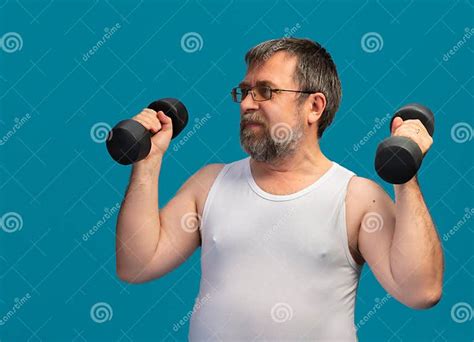 Elderly Man Strengthens Arms with Dumbbells in a Fitness Routine at ...