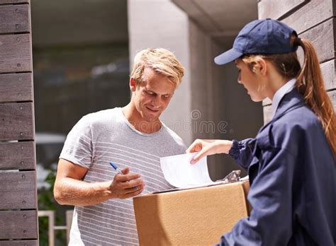 It always Arrives on Time. Shot of a Courier Making a Delivery To a ...