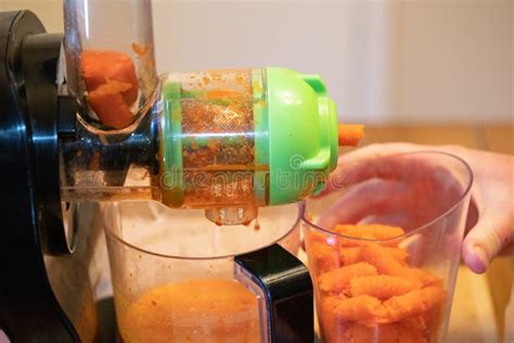 Juicing Carrots stock image. Image of hand, juicer, juicing - 180548823