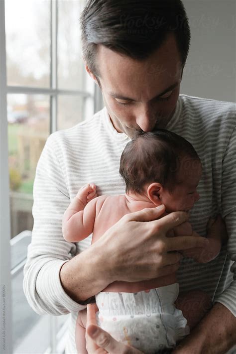 "Content New Dad Holding Baby At Home Snuggling" by Stocksy Contributor ...