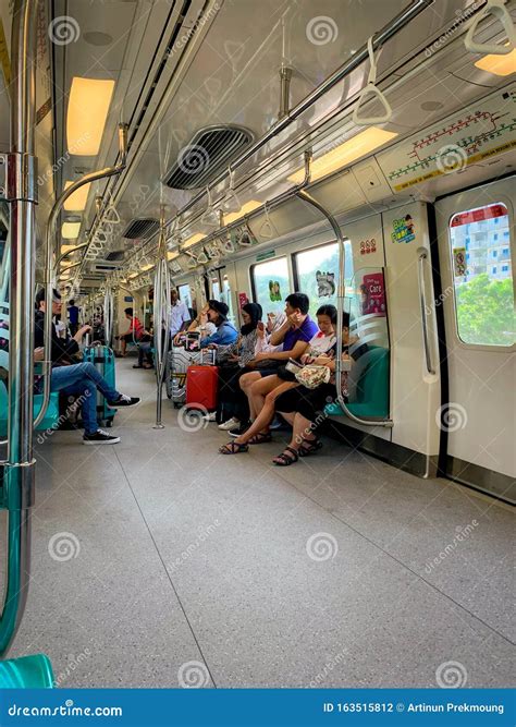 Tourist On MRT Train. Asian People Using Smartphone Inside Train