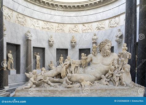 A Marble Statue of a Naked Man Lying in Water and Surrounded by Many 