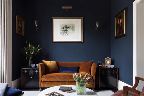 Bright living room space painted with deep dark blue walls and dull ...