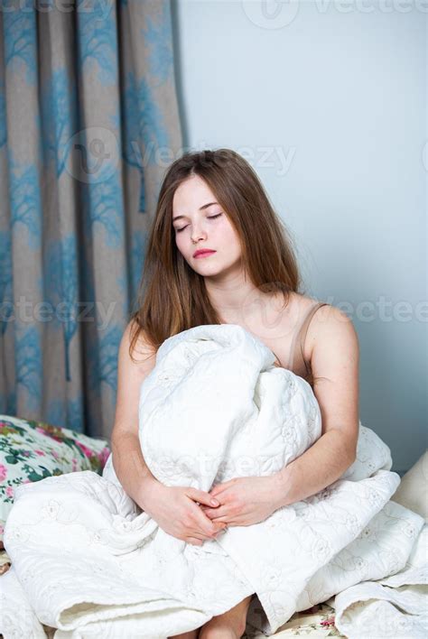 Girl sleeps in a white bed at home. Young woman sleeping in sleepwear