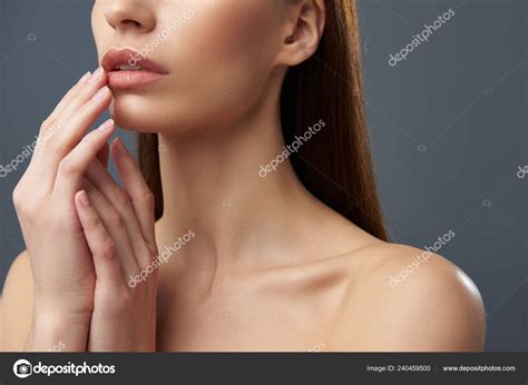 Young woman with beautiful full lips posing on blue-gray background ...