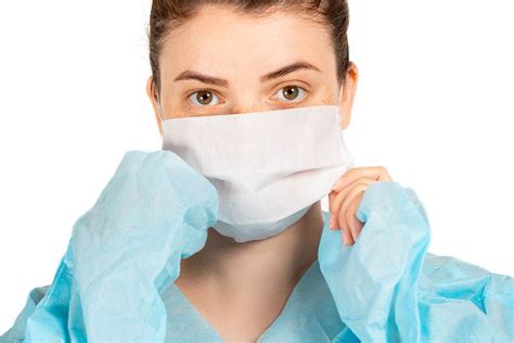 A girl sitting on the toilet, holding a glass of water and medical ...