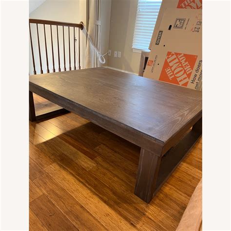 Ashley Cariton Wood Coffee Table - AptDeco