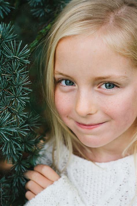 "Portrait Of A Smiling Little Girl , Standing Next To A Fir Tree." by