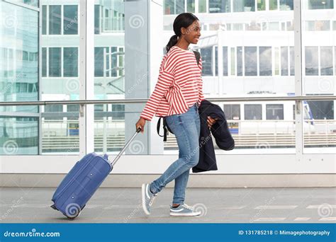 young black woman traveling  suitcase  station stock photo