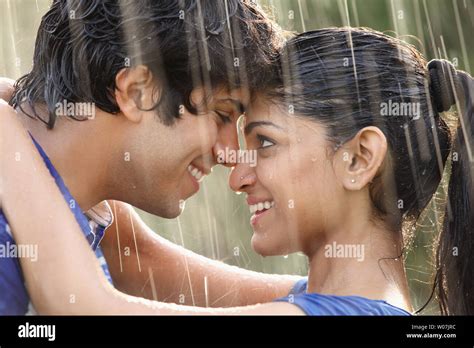 Indian young couple romancing in the rain Stock Photo - Alamy