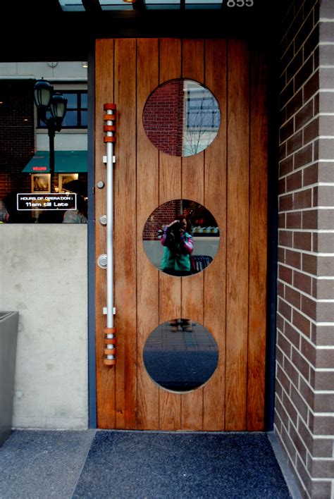 wood paneled door with round windows, vancouver in 2025 | Front door