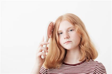 premium photo teenager girl brushing  hair