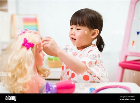 toddler girl pretend play as hairdresser at home Stock Photo - Alamy