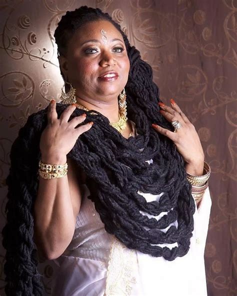 Woman with 19ft-long dreadlocks she's grown for 40 years hugs hair when