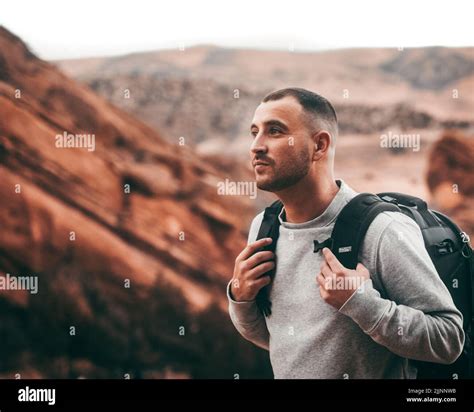 An attractive man hiking at the beautiful Red Rocks Park and ...