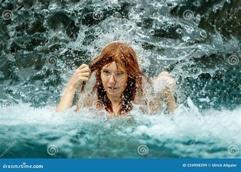 Beautiful Redhead Woman in Bikini Under the Splashing Water Shower of