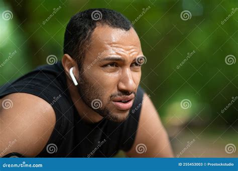 closeup portrait  african american young guy jogging  park stock