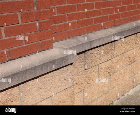 red brick traditional masonry pattern  concrete block wall separated