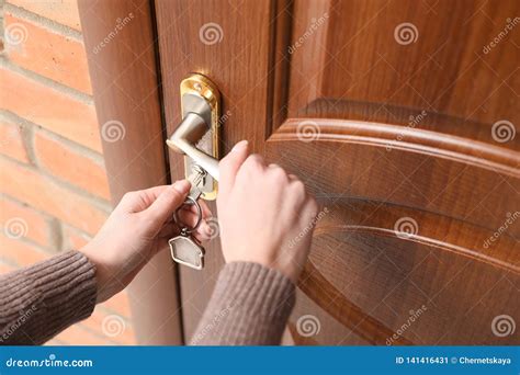 woman  key opening front door stock image image  home indoors
