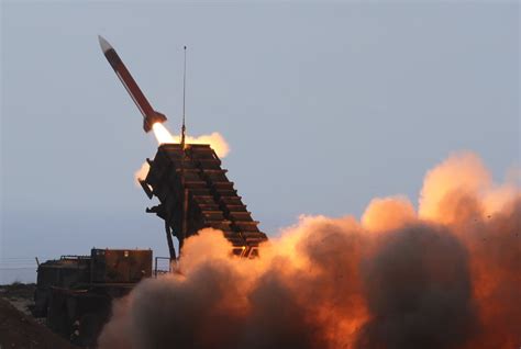 A Patriot missile leaves the launcher tube on its way to intercept a ...