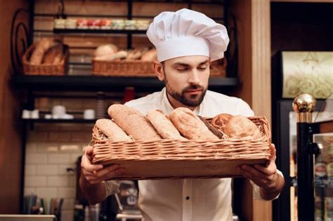Premium Photo | Young Bearded Man in White Cap Standing in Bakery ...