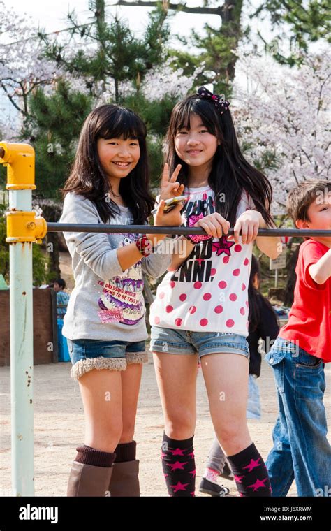 Japan, Shukugawa. Two pre-teen Japanese girls in t shirts and cut Stock
