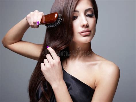 beautiful girl combing  hair fashion beauty portrait stock photo