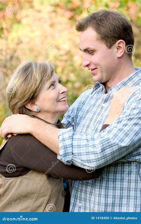 Young man and mature woman stock photo. Image of cuddle - 1418400