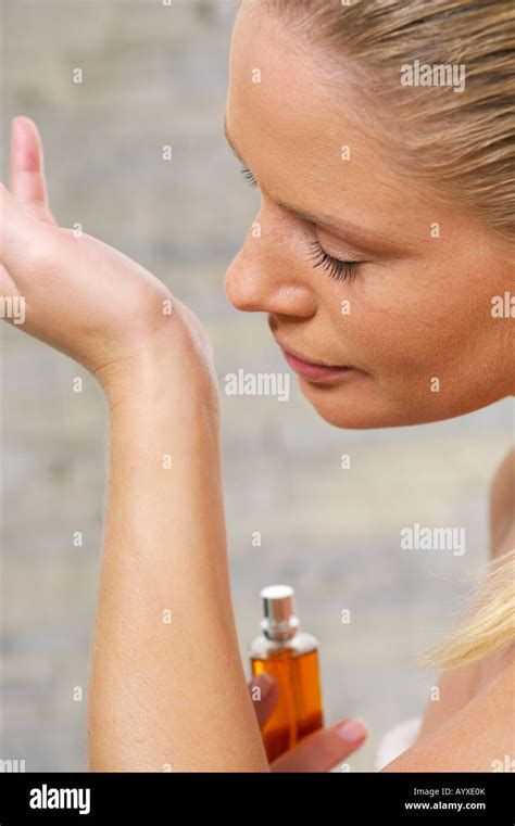 young woman smelling perfume  hand stock photo alamy
