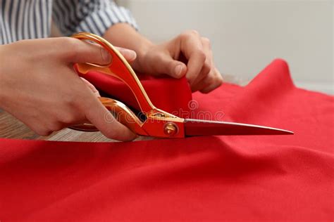 woman cutting fabric  sharp scissors  wooden table stock image